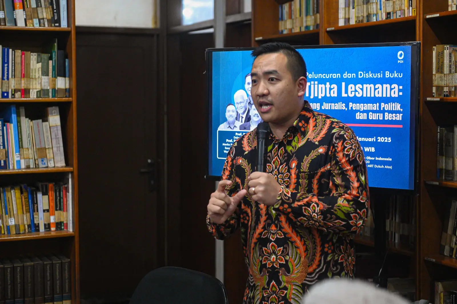 William Ndut speaking on stage — moment 01