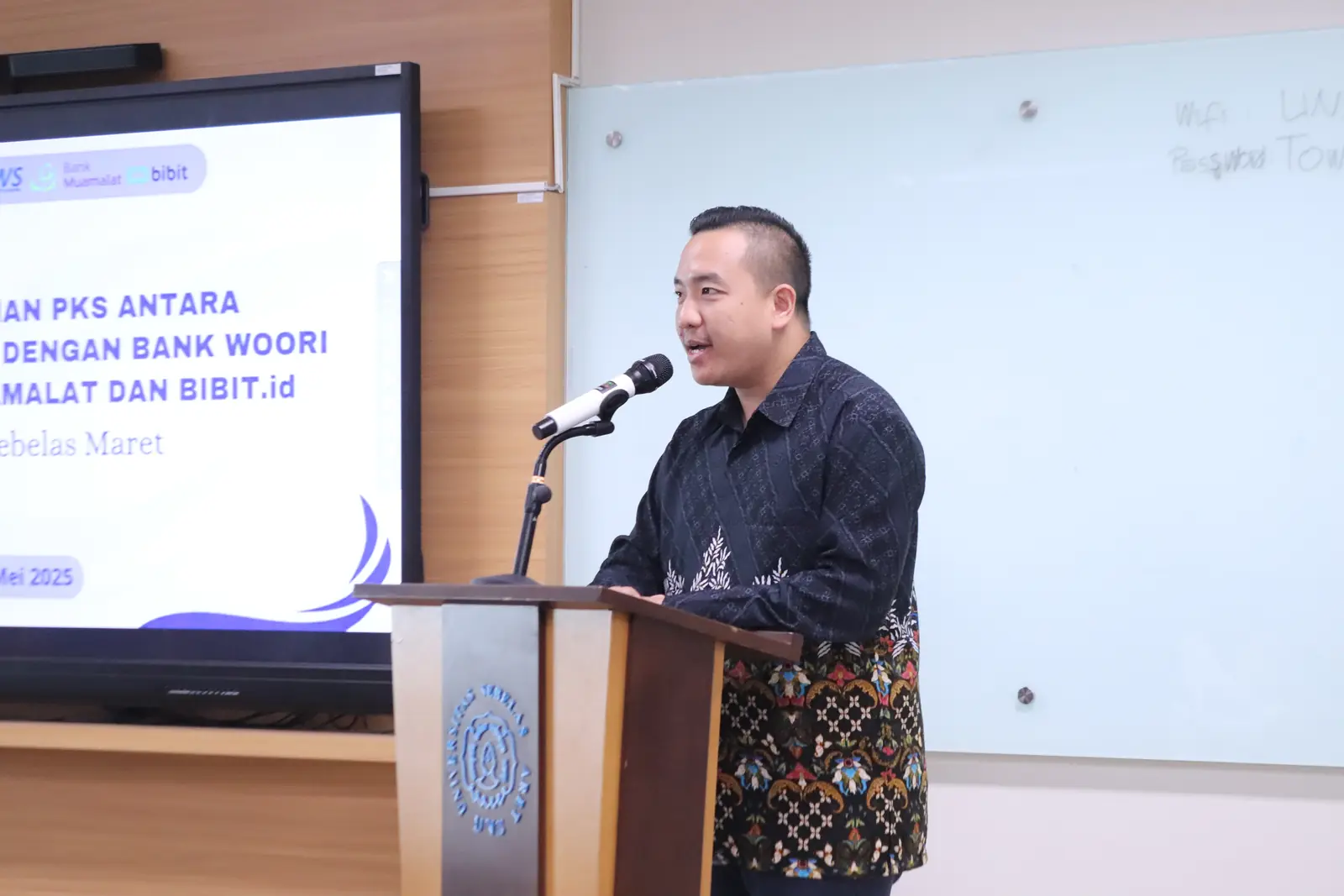William Ndut speaking on stage — moment 02