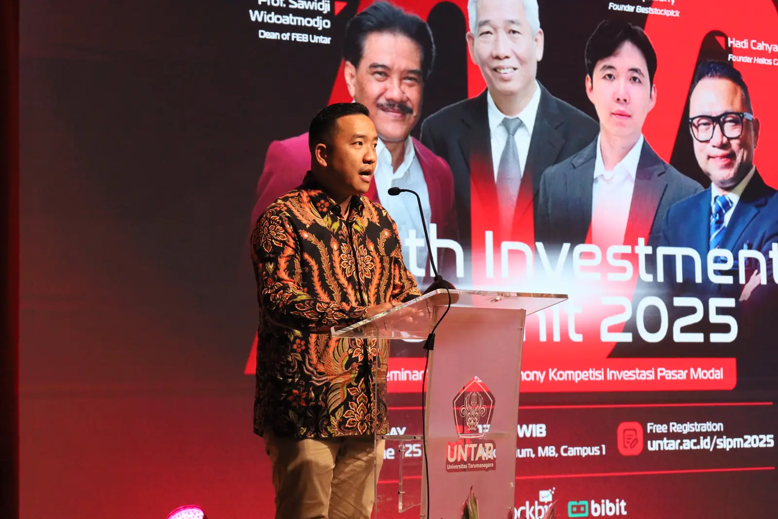William Ndut speaking on stage — moment 05