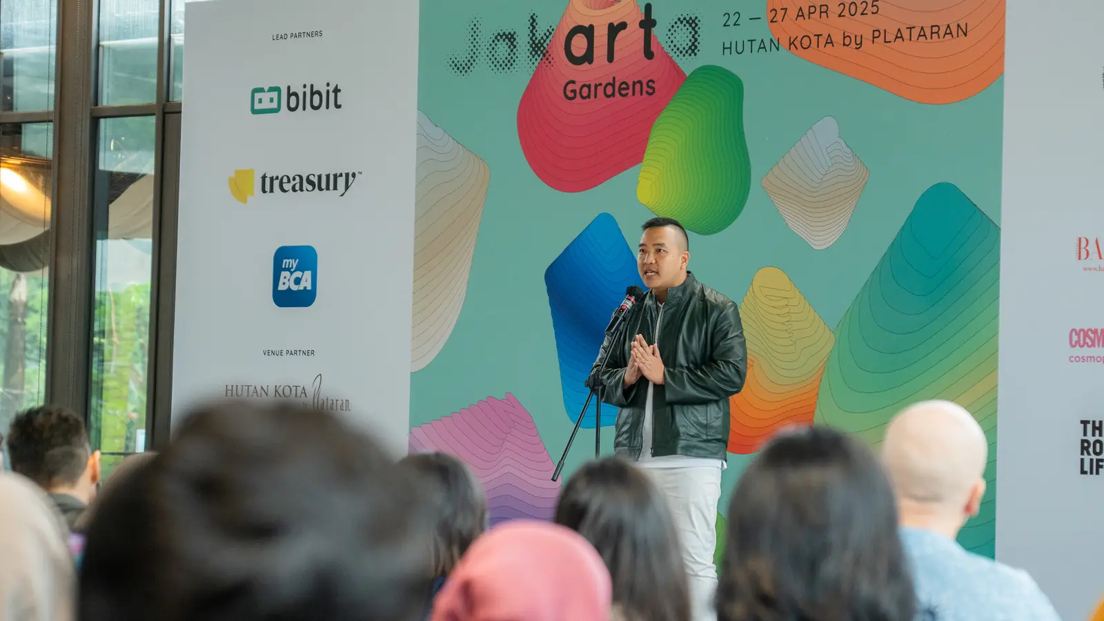 William Ndut speaking on stage — moment 08