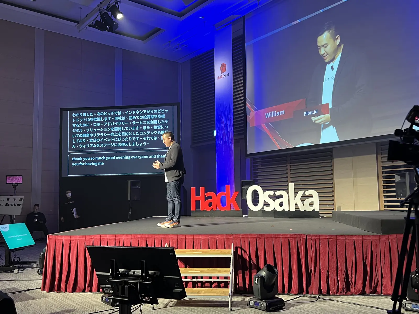 William Ndut speaking on stage — moment 10