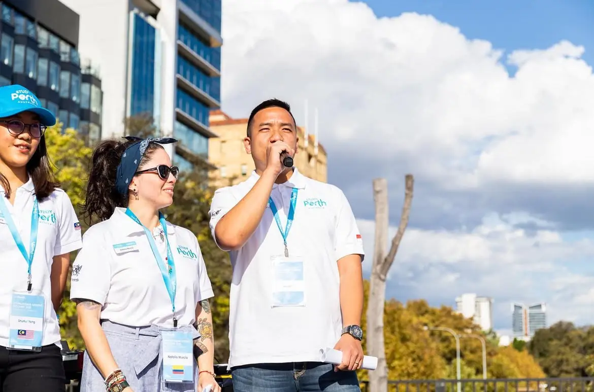 William Ndut speaking on stage — moment 14