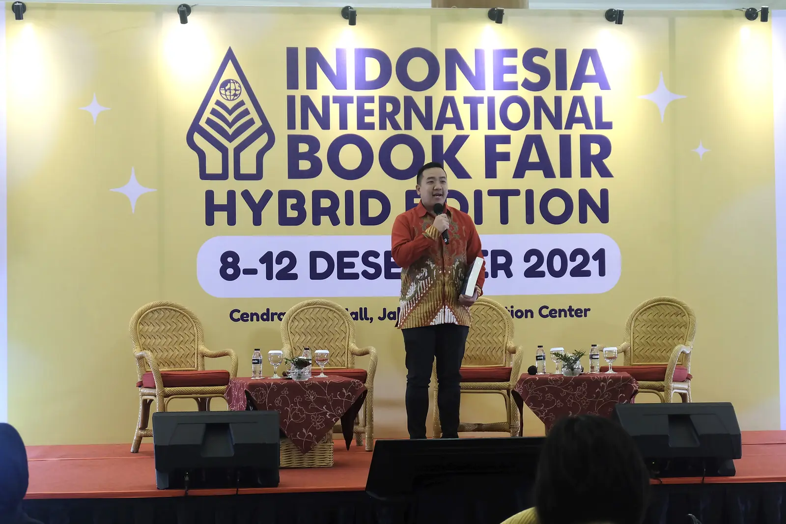 William Ndut speaking on stage — moment 15