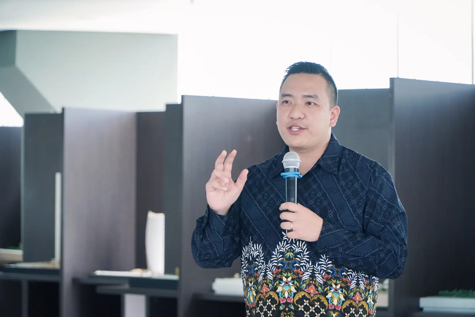 William Ndut speaking on stage — moment 16