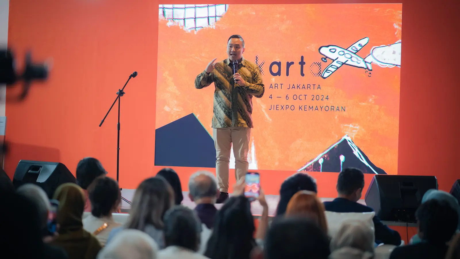 William Ndut speaking on stage — moment 17