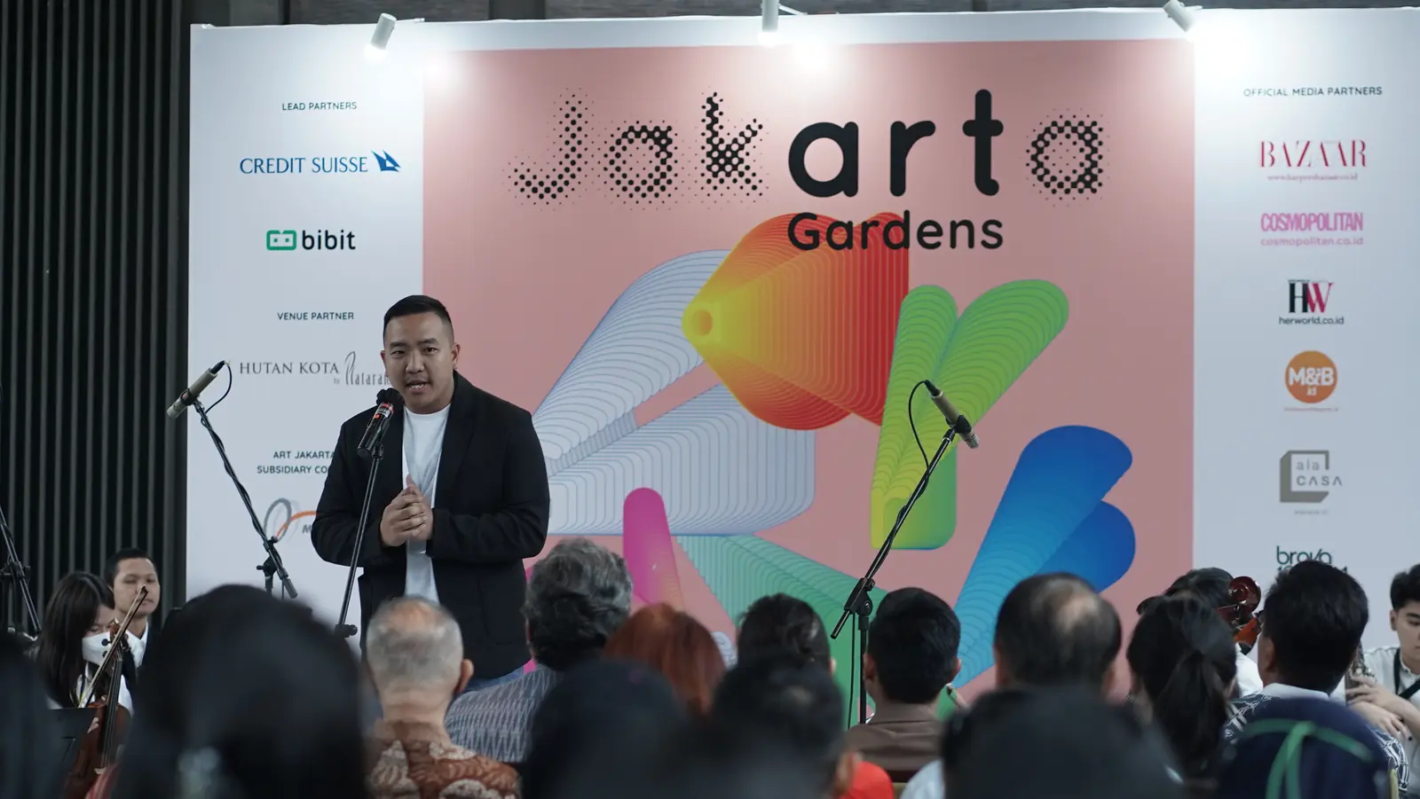 William Ndut speaking on stage — moment 19