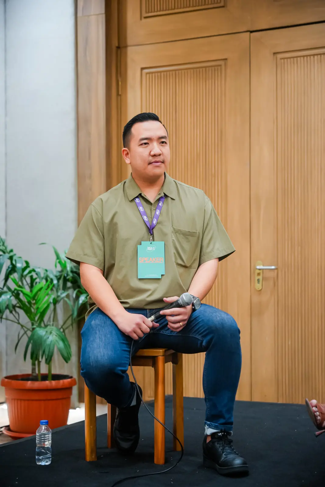 William Ndut speaking on stage — moment 21