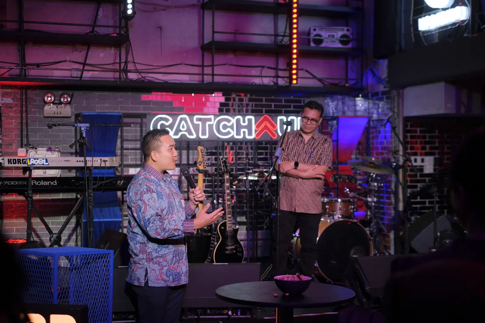 William Ndut speaking on stage — moment 22
