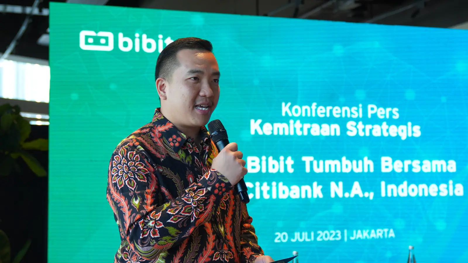 William Ndut speaking on stage — moment 23