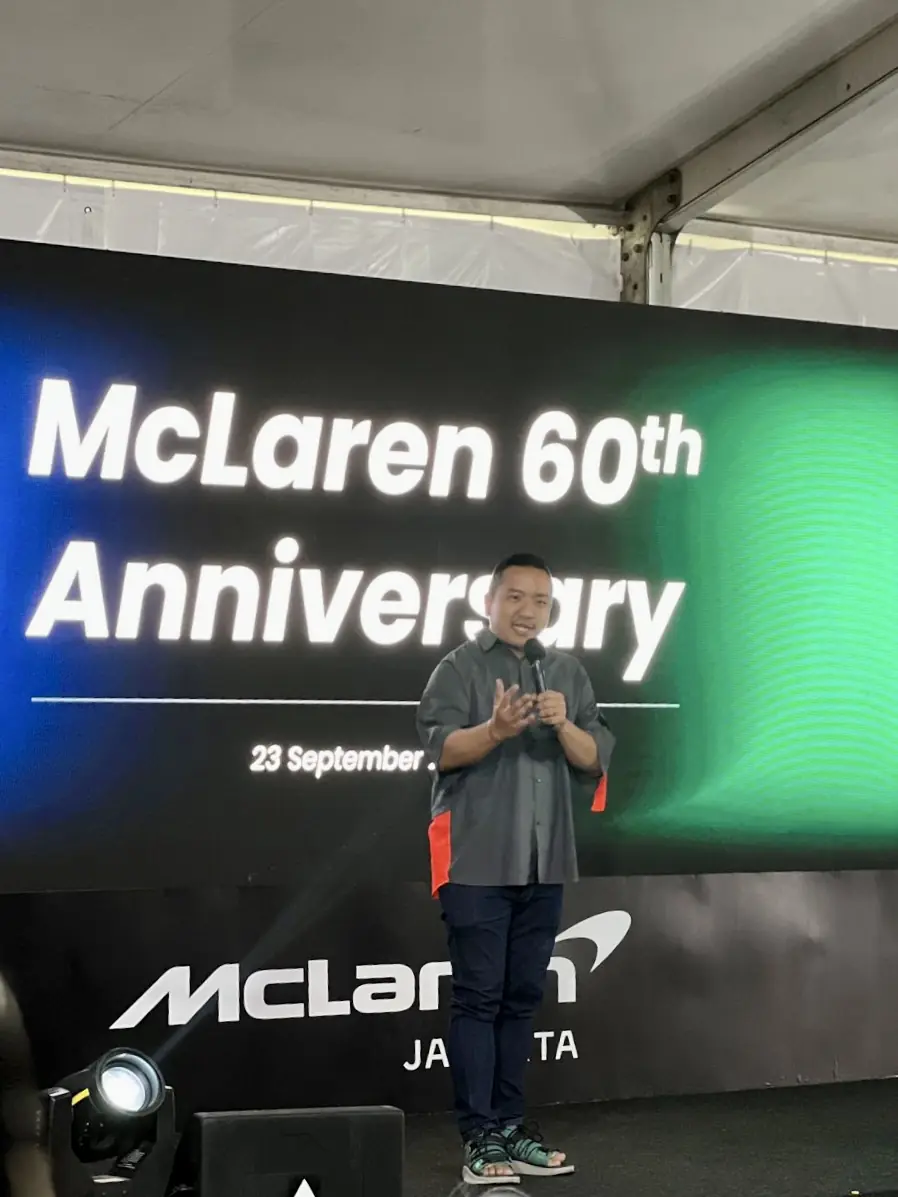 William Ndut speaking on stage — moment 30